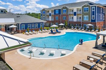 Resort-style swimming pool with sun shelf and expansive sundeck